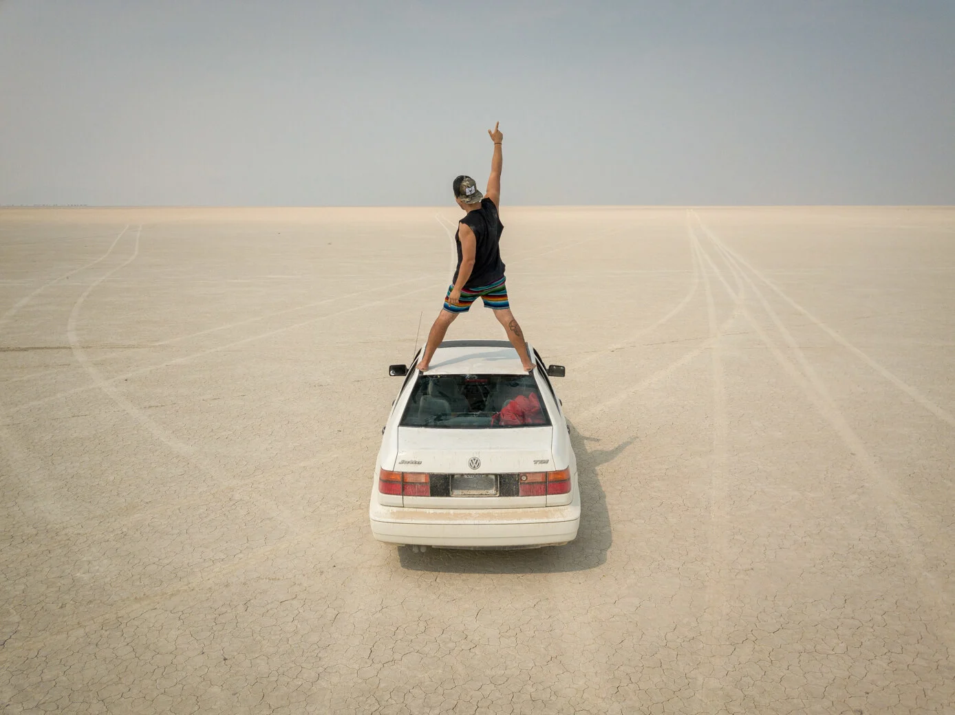 Man standing on car in Alvord Desert
