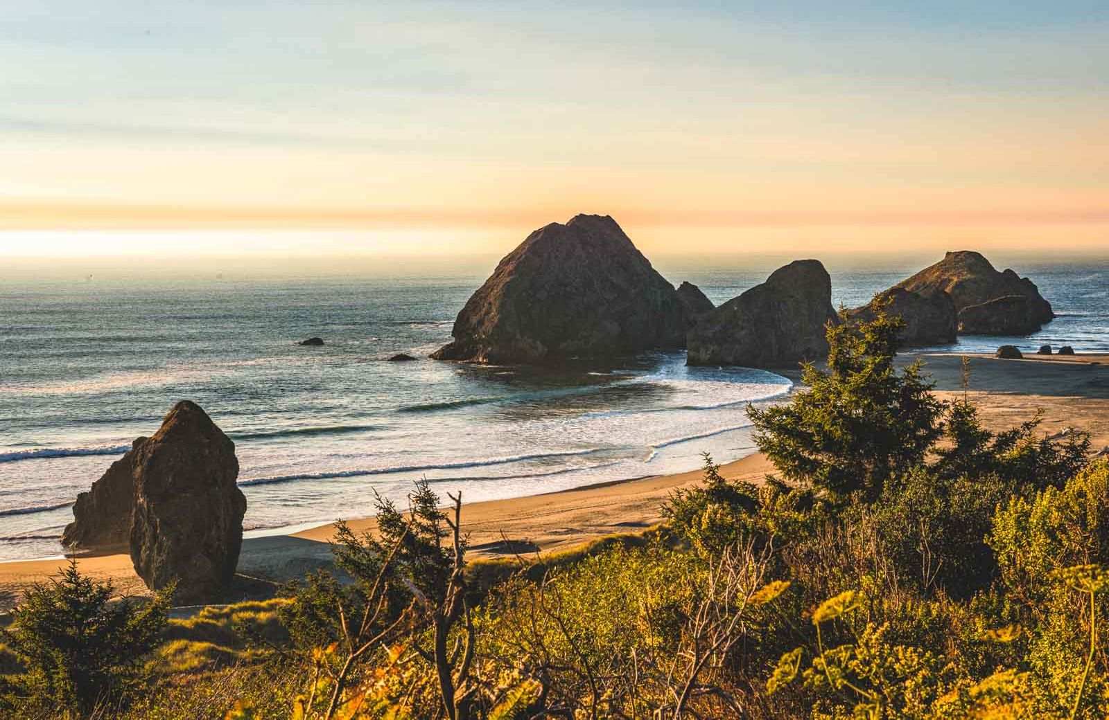 Gold beach with a few random rocks along the shoreline.