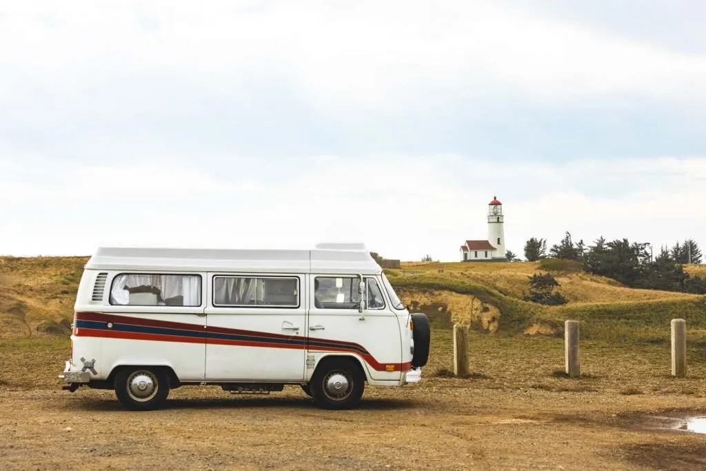 Van parked in foreground of Cape Blanco Lighthouse, a must visit Oregon Lighthouse.