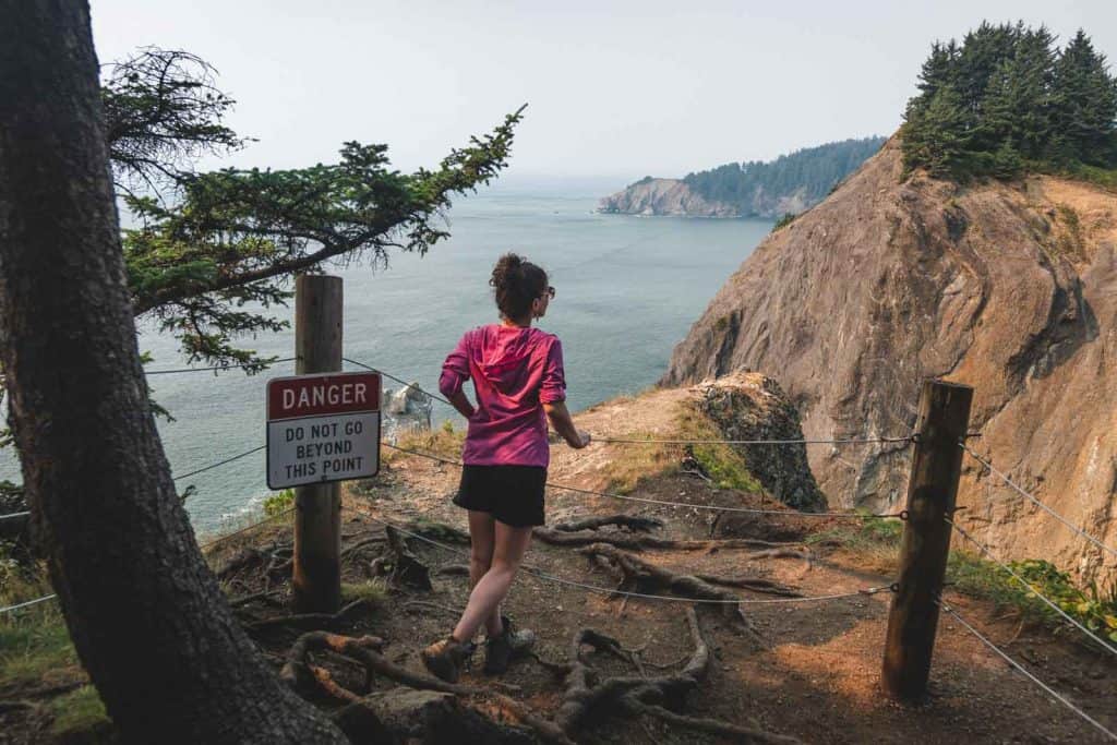 Woman running along coastline near Cape Falcon in Oregon