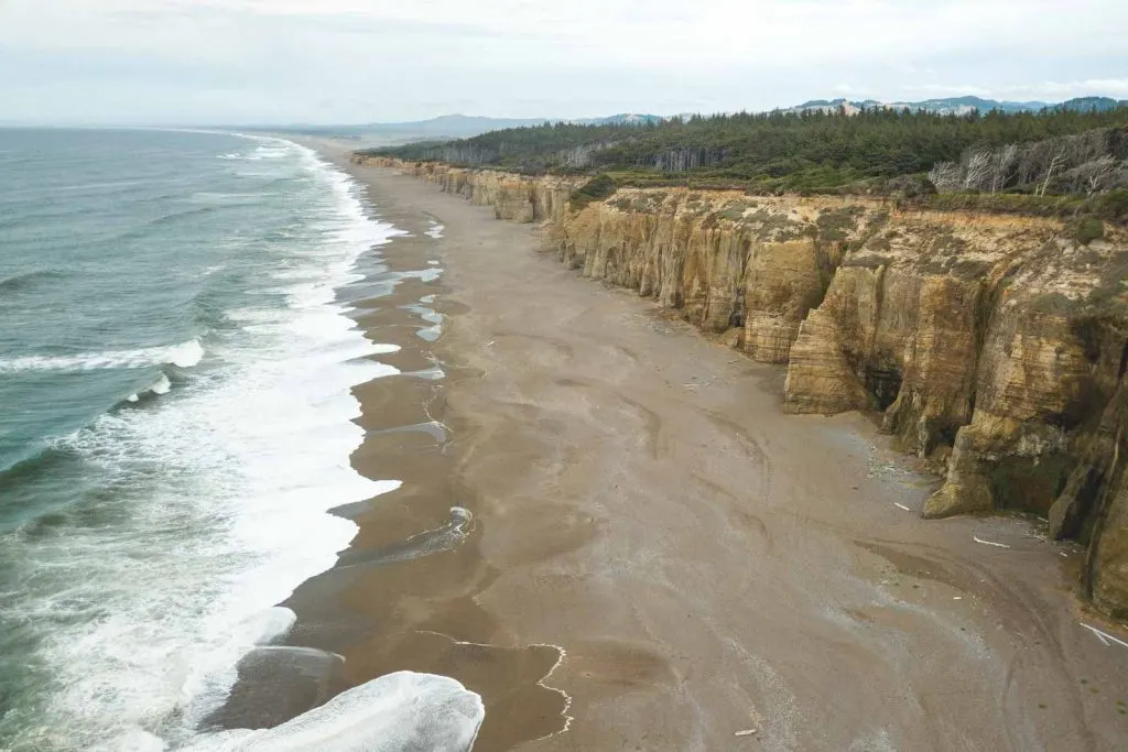 View of beach and sea cliffs at Floras Lake State Park on the Oregon Coast