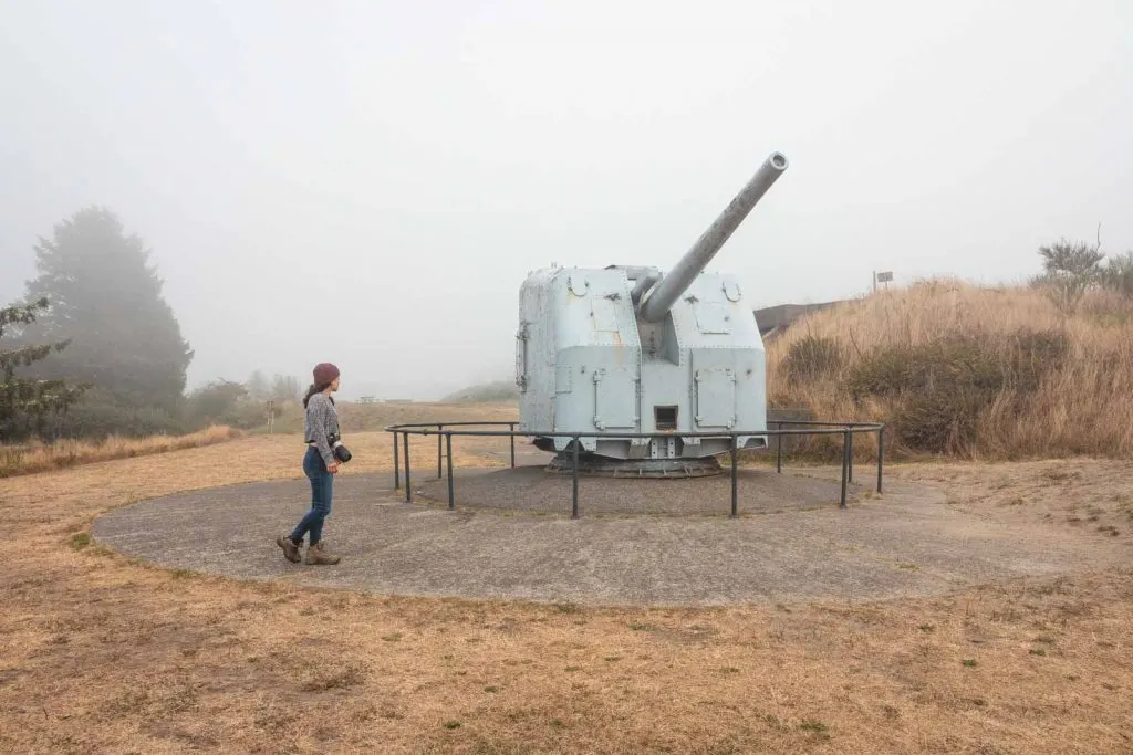 Person in front of military gun at Fort Stevens Oregon Coast State Park