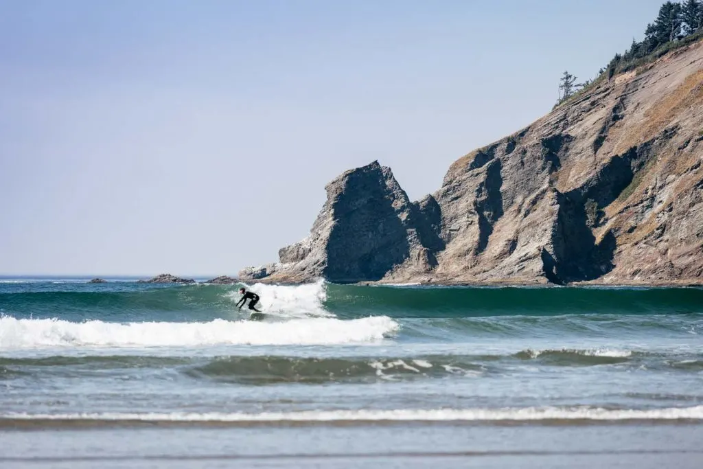 Surfer catching a wave on Short Sands Beach