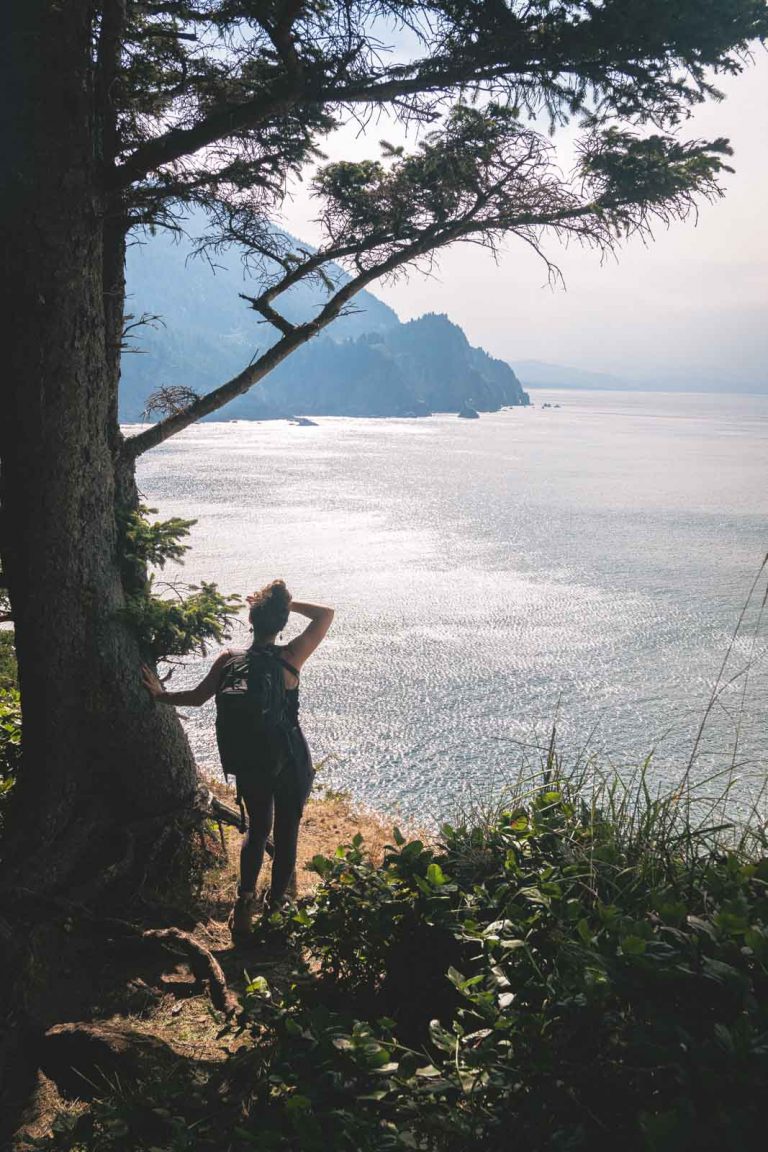 Hiker looking out to the ocean on the Cape Falcon Trail
