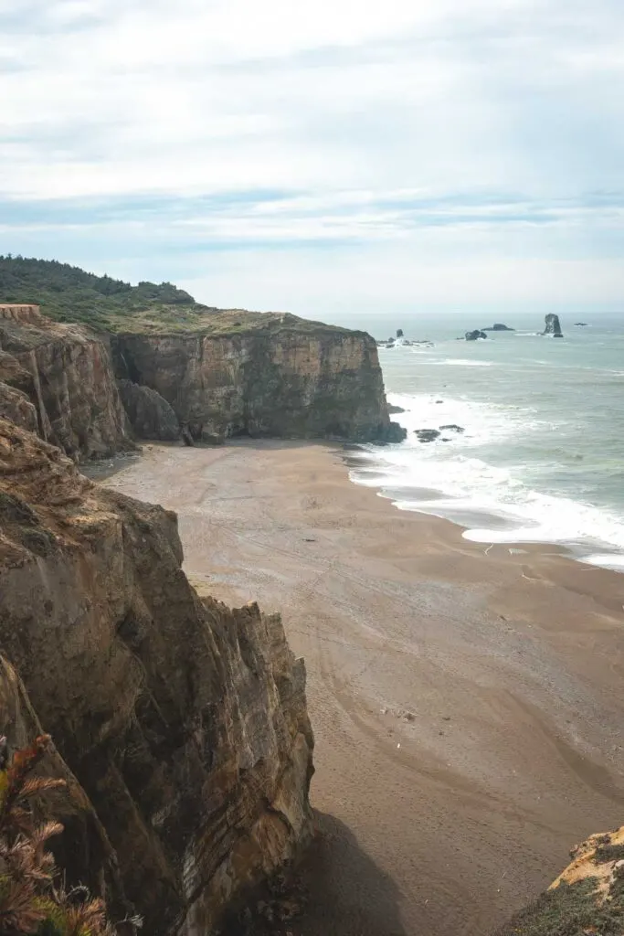 View over beach and seacliffs at Floras Lake State Park, one of the best beaches on the Oregon Coast