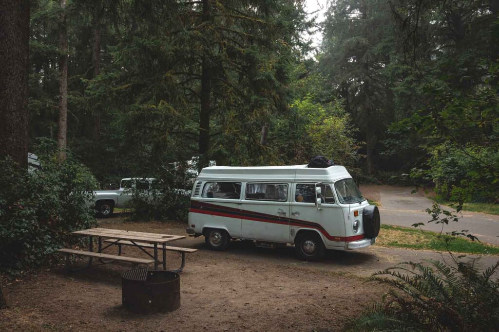 VW van at campsite in the woods at Fort Stevens State Park near Seaside Oregon.