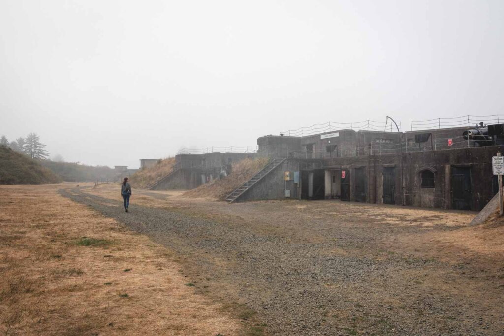 Person walking by structure in Fort Stevens State Park in Oregon