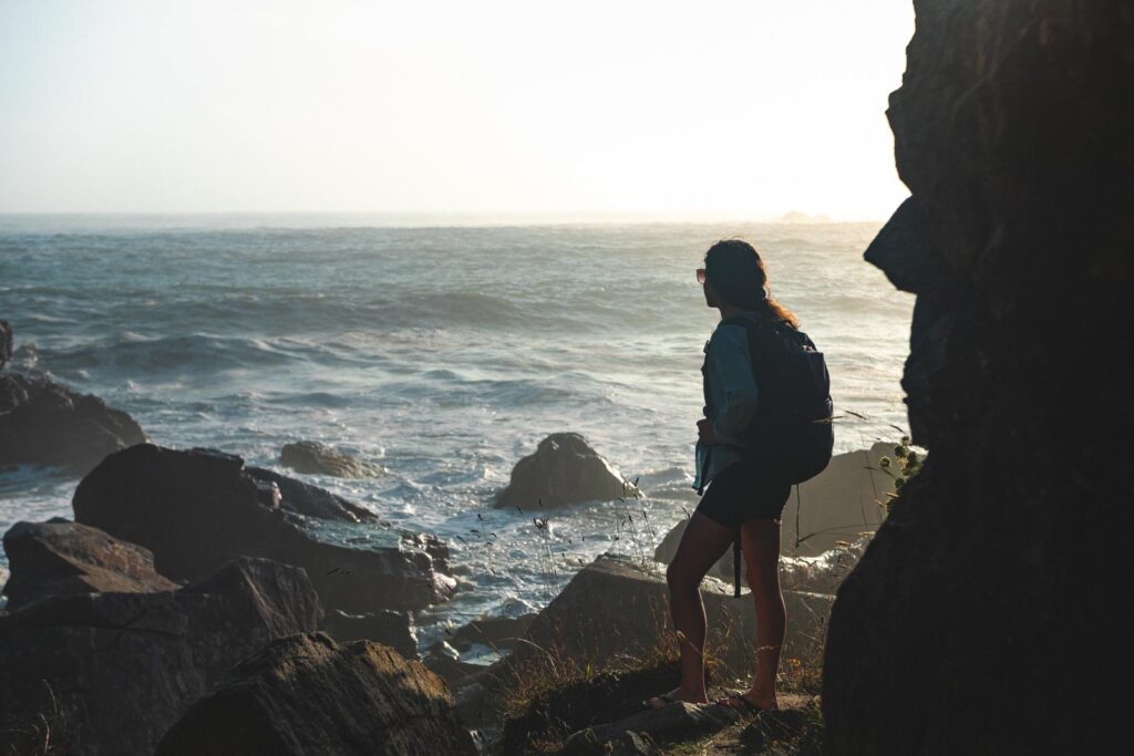 Two people looking out at the ocean at Harris Beach State Park in Oregon