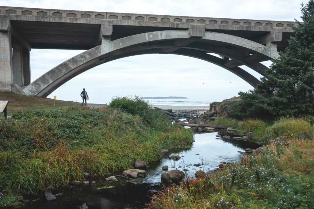 Person standing under bridge with ocean in background at Beverly Beach near Newport Oregon