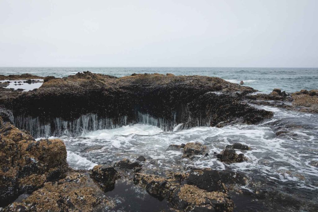 Close up shot of Thor's Well - a rocky cauldron in the ocean