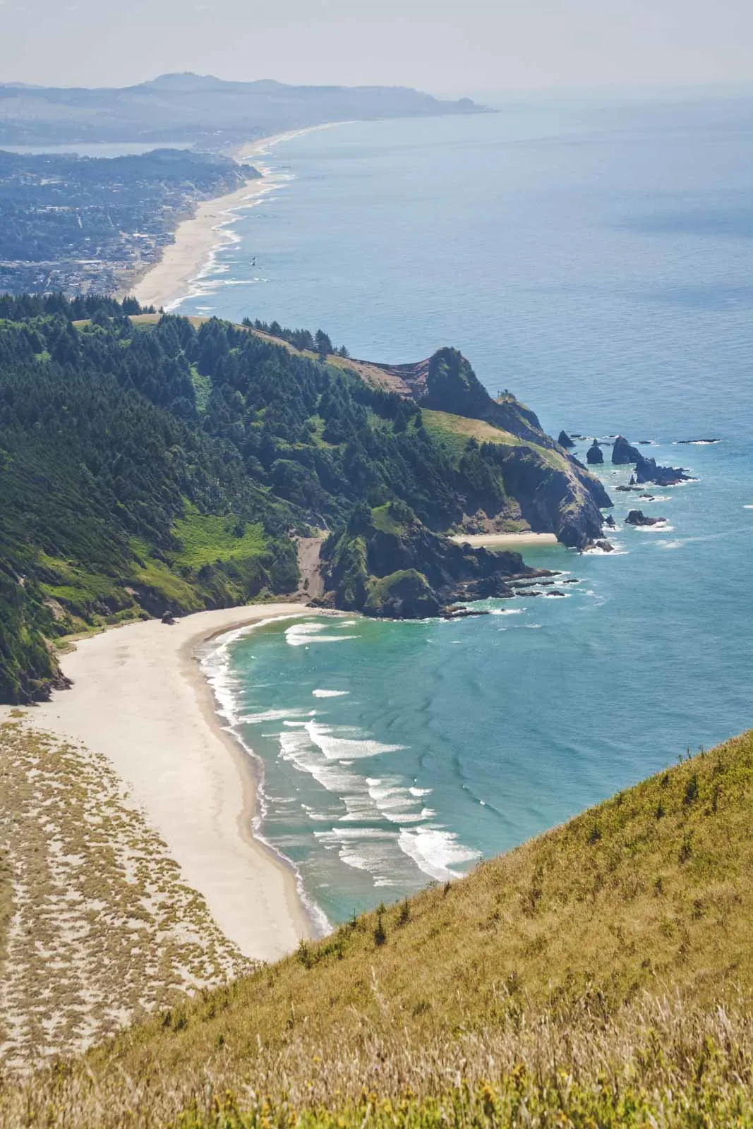 Aerial view over beach, ocean and headland from Harts Cove trail near Lincoln City