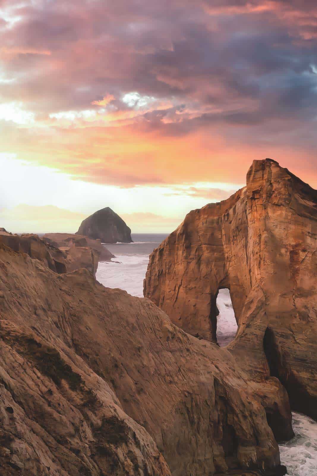 View over sea arch, coastline and island at sea at sunset from Cape Kiwanda