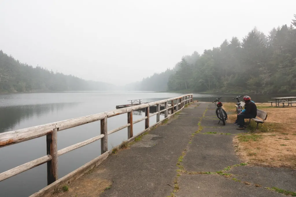 Two bikes on paved trail by Coffenbury Lake in Fort Stevens State Park