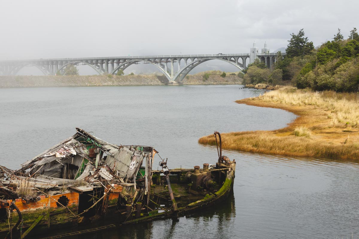 Mary D Hume shipwreck in water with bridge in background at Gold Beach.
