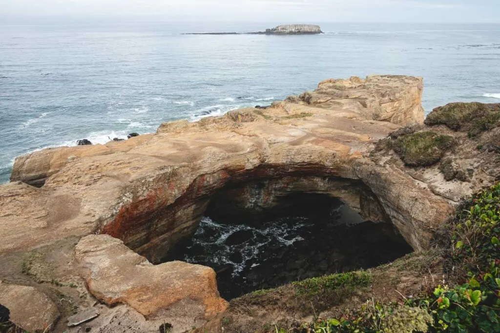 View over Devils Punch Bowl collapsed cave with ocean in the background