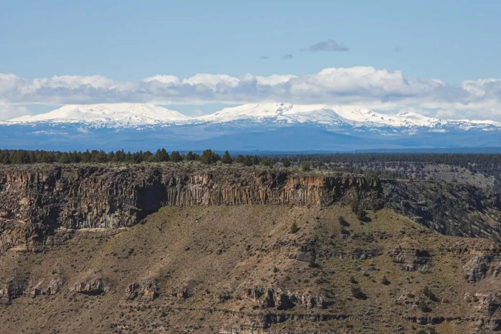 Canyon and snowcapped mountains on the Crooked River Rim Trail