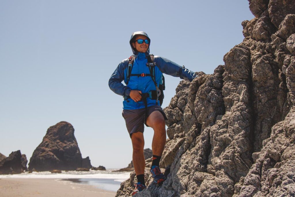 Man in hiking gear on rocks at Gold Beach