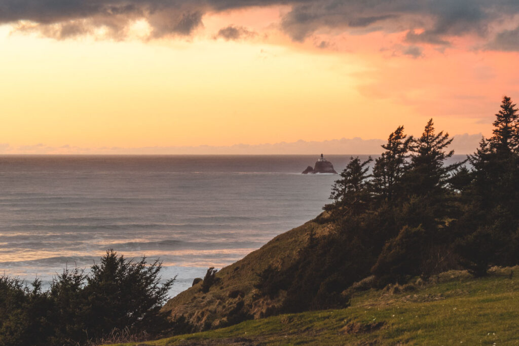 Sunset over Pacific Ocean with Tillamook Rock Lighthouse.