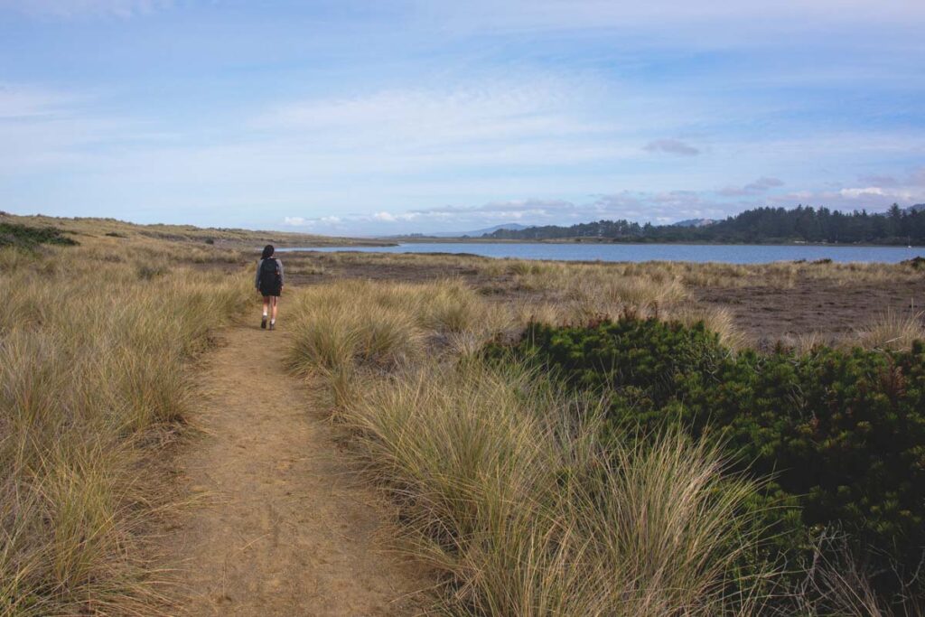 Woman hiking the Floras Lake Loop Trail