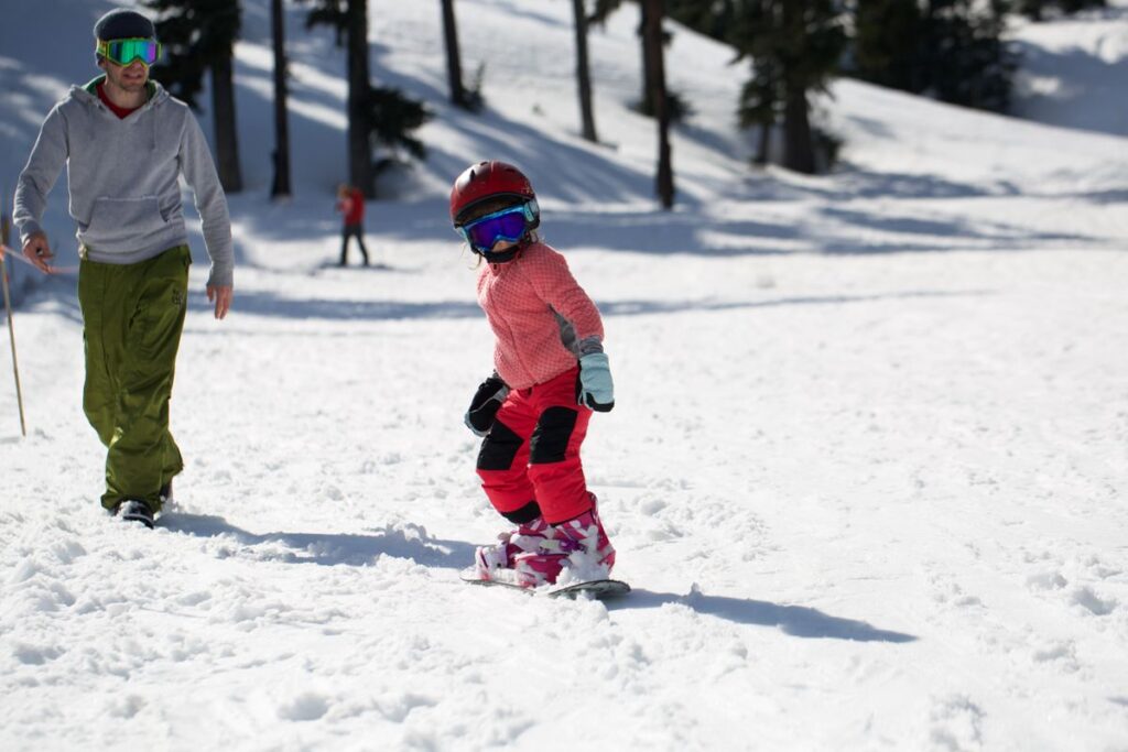 Child snowboarding on Mount Hood in winter