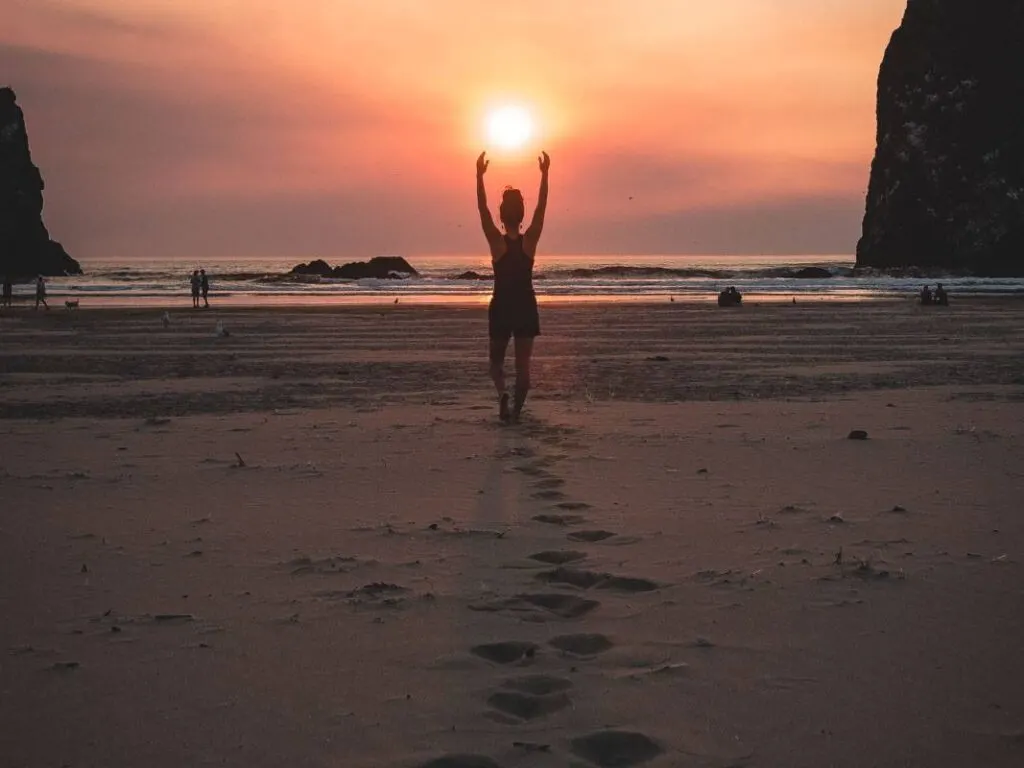 Woman on beach at sunset at Cannon Beach Northern Oregon