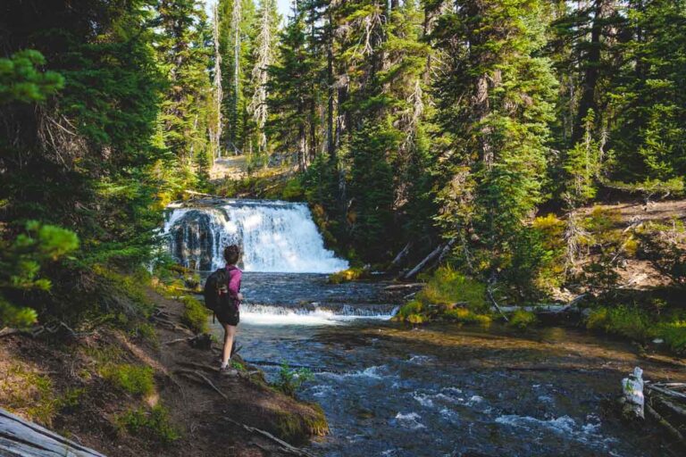 Hiker at waterfall on the Green Lakes Route of the Moraine Lake Trail