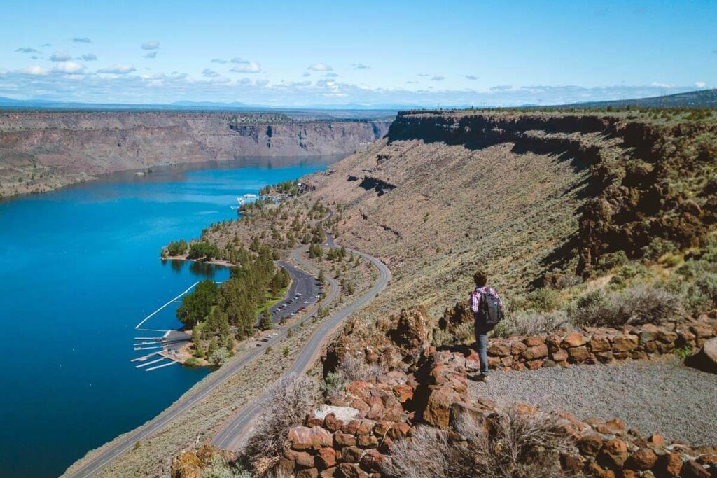 Hiker overlooking river at Cove Palisades State Park for things to do near Sisters
