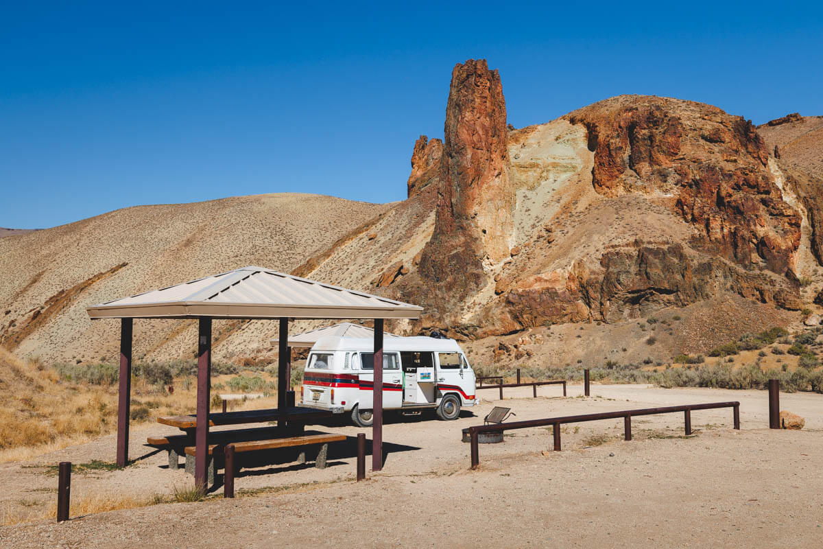 A campervan parked at Slocum campgrounds, with rocks all around.