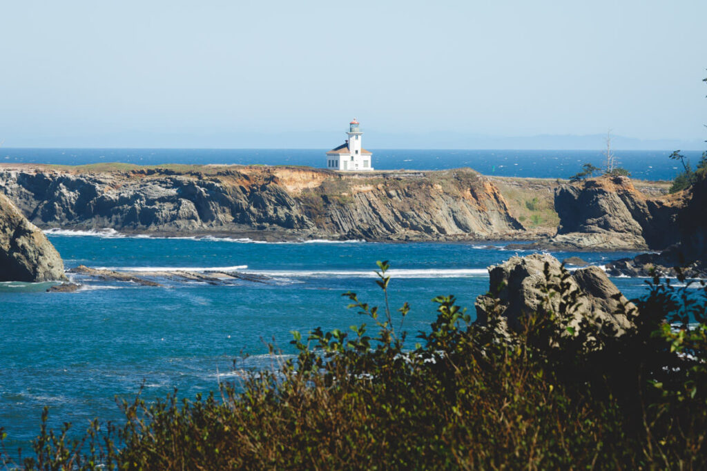 View of Cape Arago Lighthouse on a headland in Sunset Bay State Park.