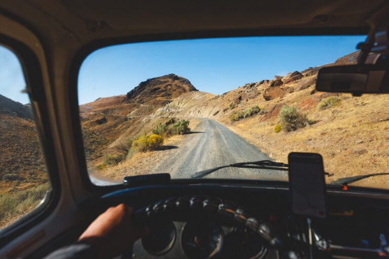 The interior of a campervan driving along a gravel track.