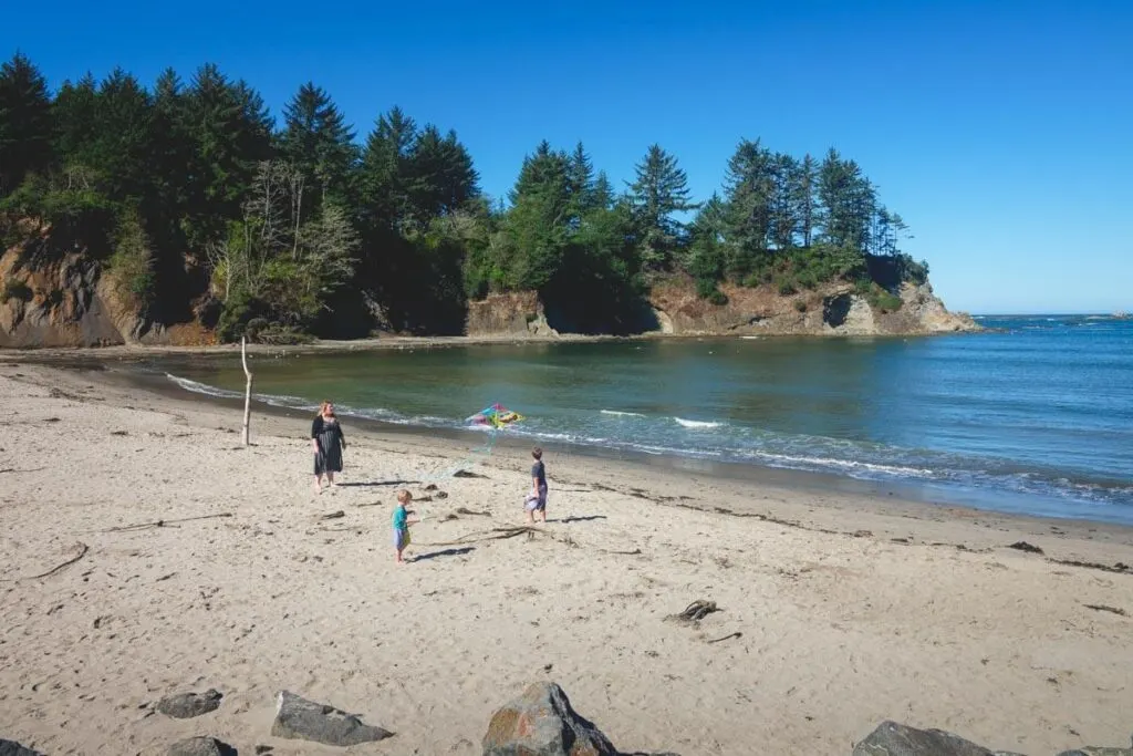 A family with a beach all to themselves in Sunset Bay State Park.