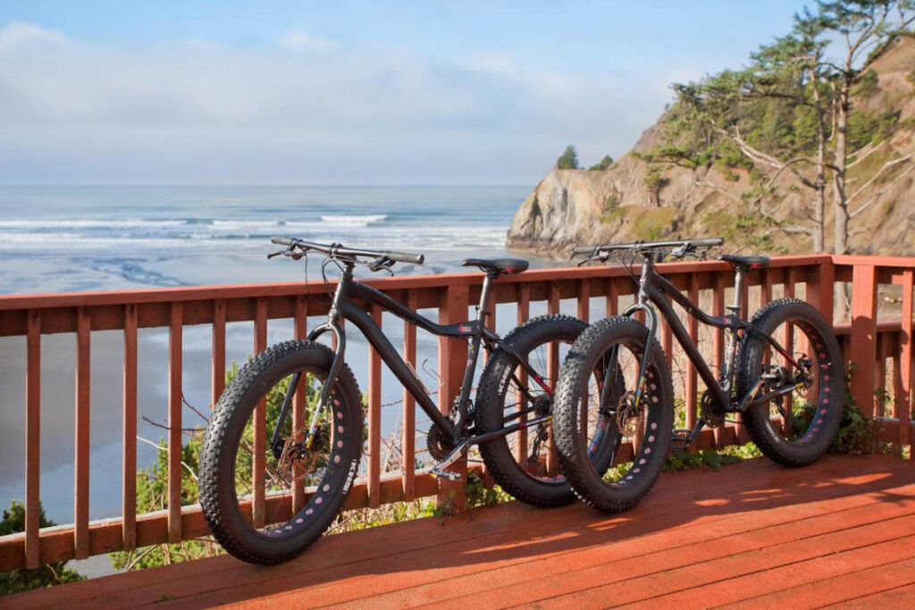 Two off-road bikes on the balcony of the Agate Beach Motel, overlooking the ocean.