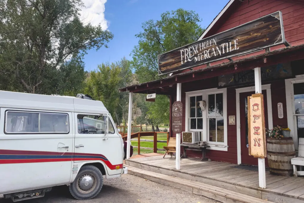 A white campervan parked outside of Frenchglen Mercantile in Oregon.
