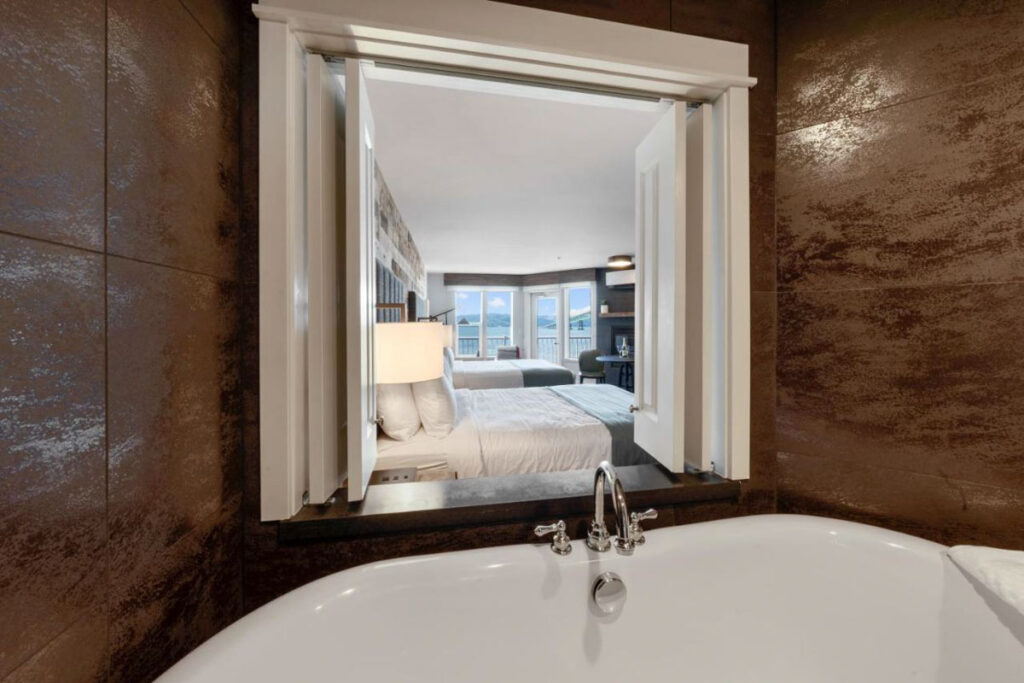 A opened window between the bathroom and the bedroom of the Cannery Pier Hotel and Spa.