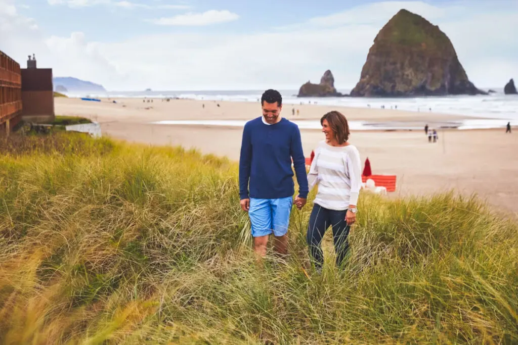 Two people standing in the area just outside of the Surfsand Resort at Canon Beach.