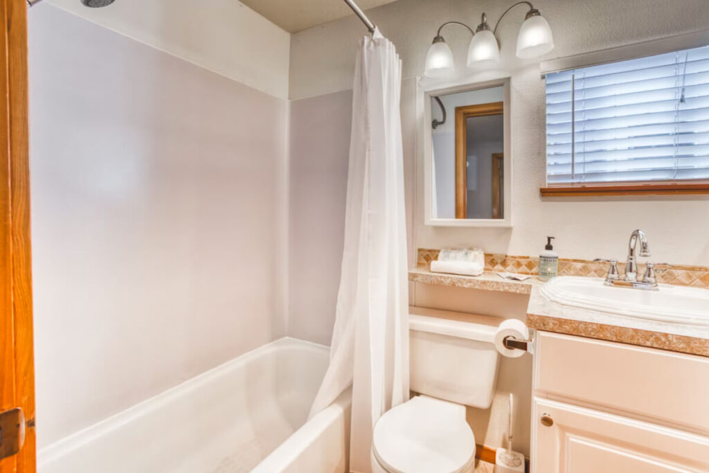 A pristine white bathroom in the Charming Cannon Beach Accommodation.