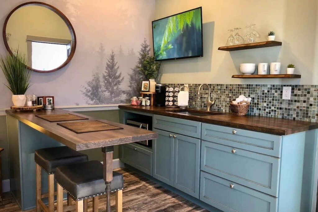 A turquoise blue kitchen in the Downtown Astoria Tiny House.