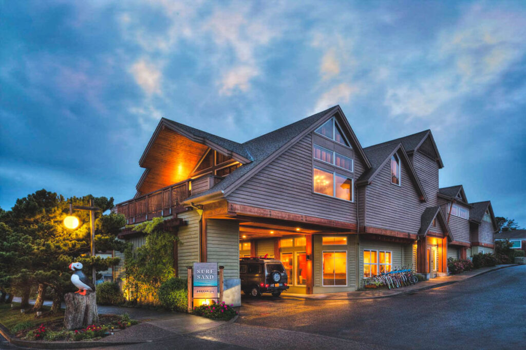 The wooden exterior of Surfsand Resort near Cannon Beach at blue hour.