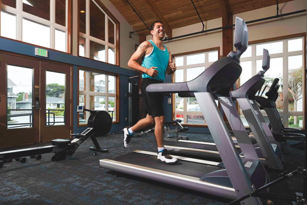 A runner on a treadmill in Surfsand Resort gym.