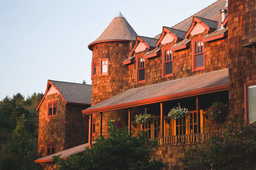The castle-like exterior of The Inn at Arch Cape near Cannon Beach in the sunset light.