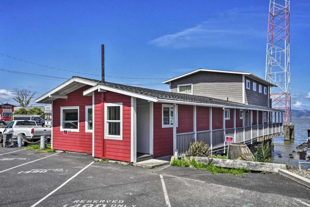 The red and gray exterior of the Waterfront Condo on the Pier which backs out over the river in Astoria, Oregon.