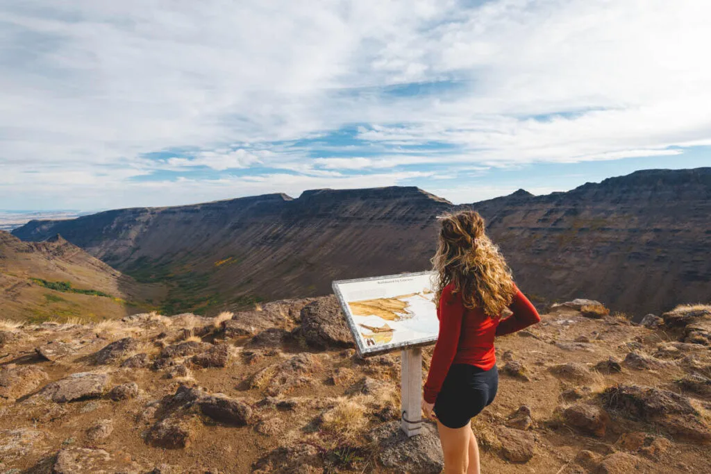 A woman studying in an information board at Kiger Gorge overlook in Steens Mountain.