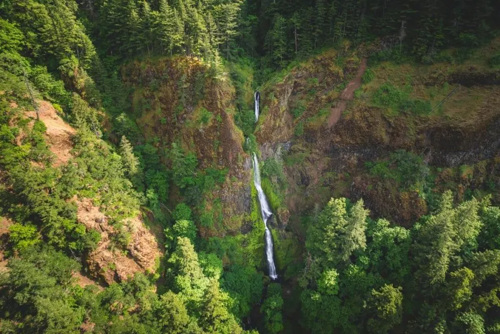 An aerial view of Starvation Creek Falls in the forests of Columbia River Gorge.