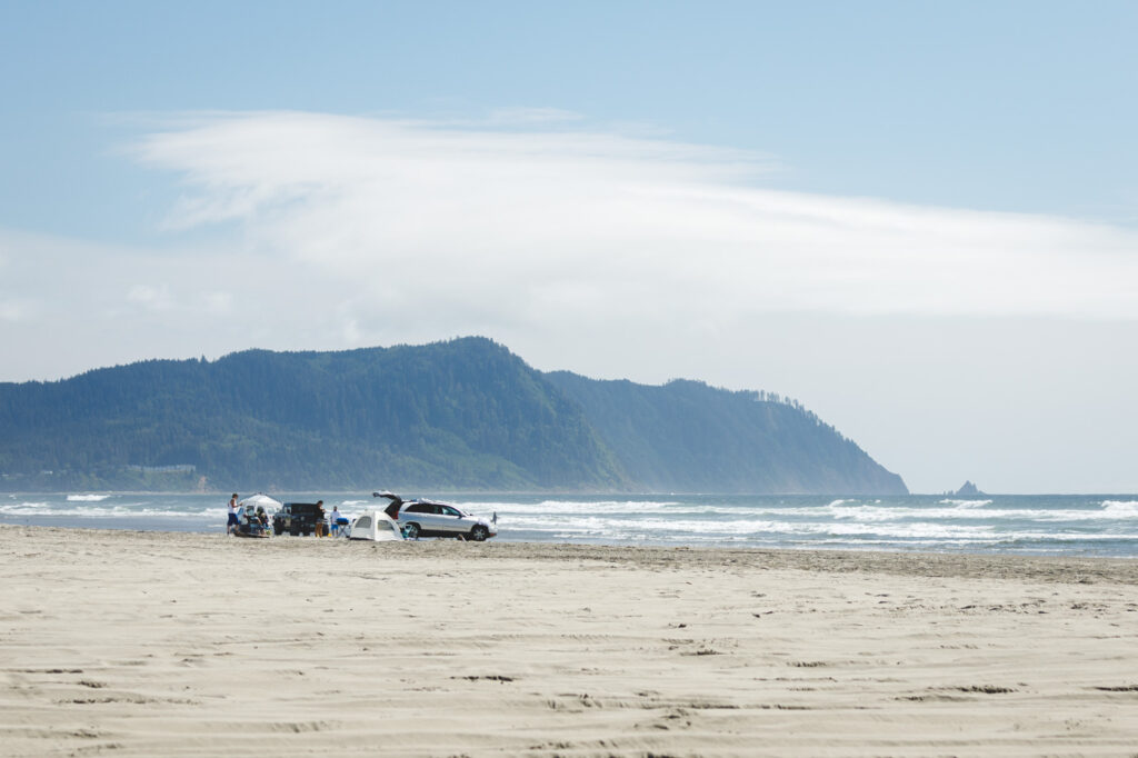 Cars and tents on Del Rey Beach State Recreation Site on a sunny day.