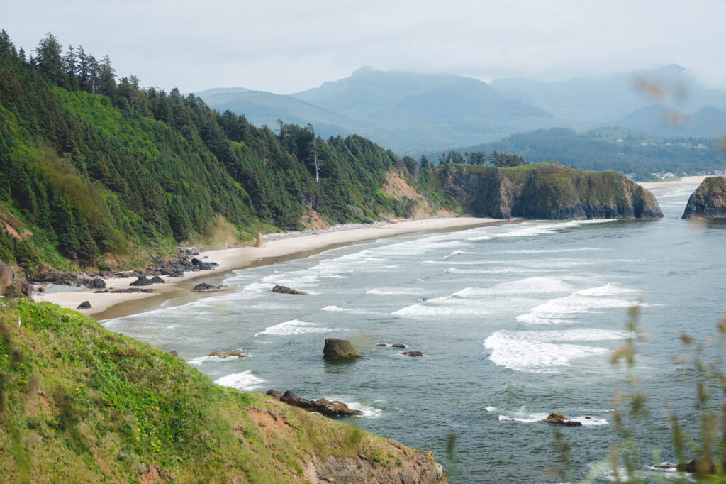 View across an empty Crescent Beach on an overcast day in Ecola State Park.