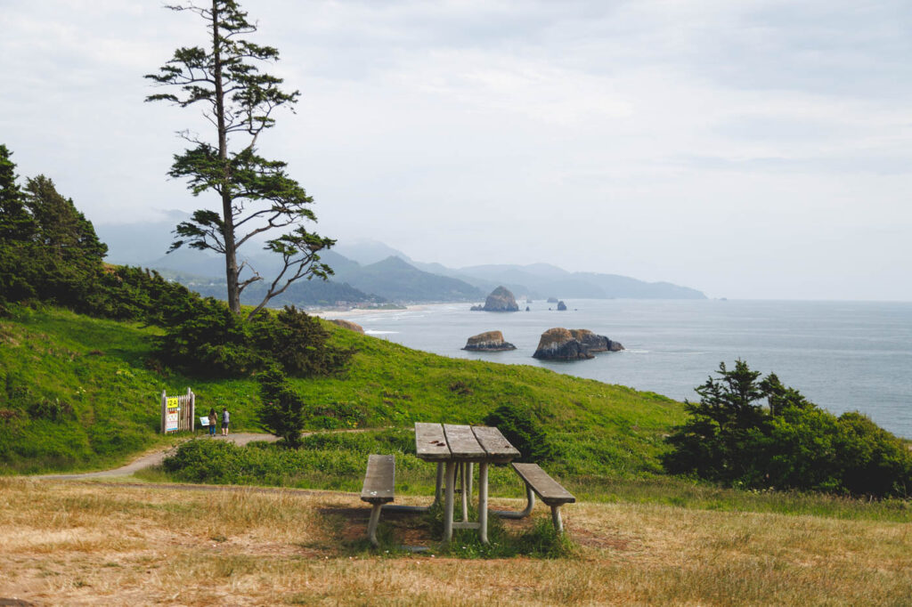 An empty picnic bench with a great view over Ecola State Park from the day use area.