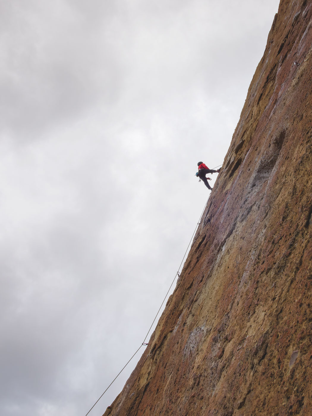 Rock climber descending a rock.