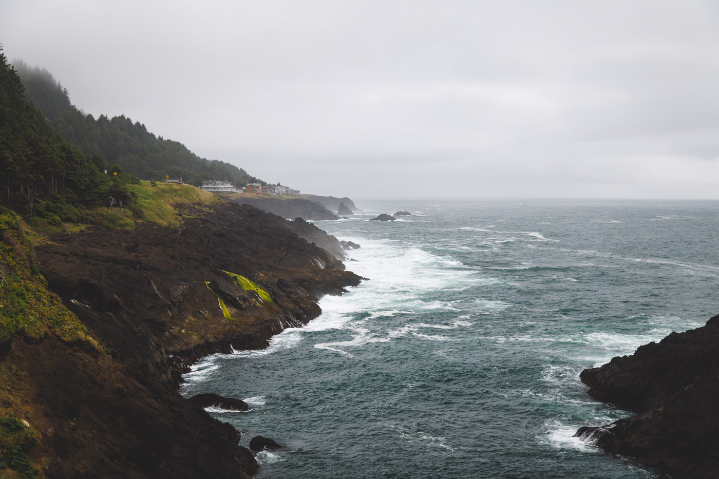 Coastline view from Rocky Creek State Scenic Viewpoint on an overcast day in Newport.