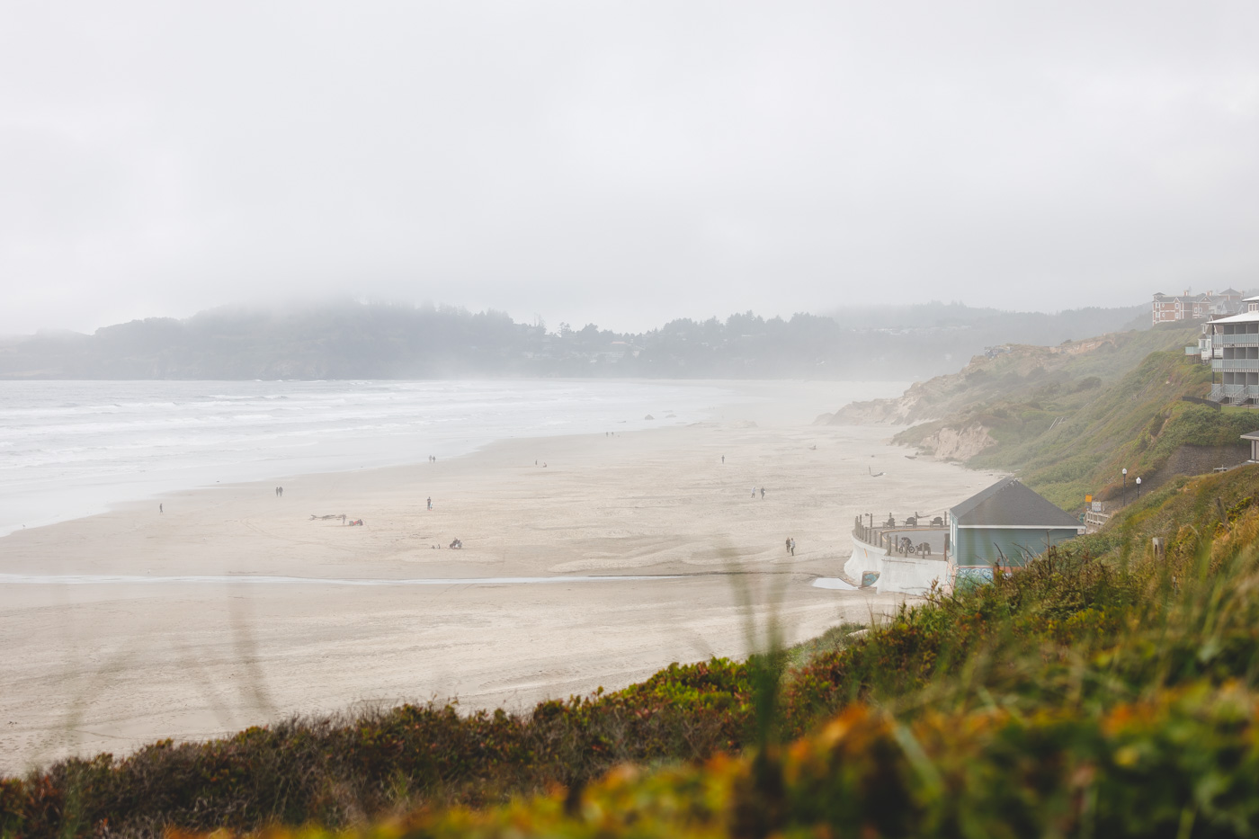 A mostly empty Nye Beach on a foggy and overcast day in Newport.