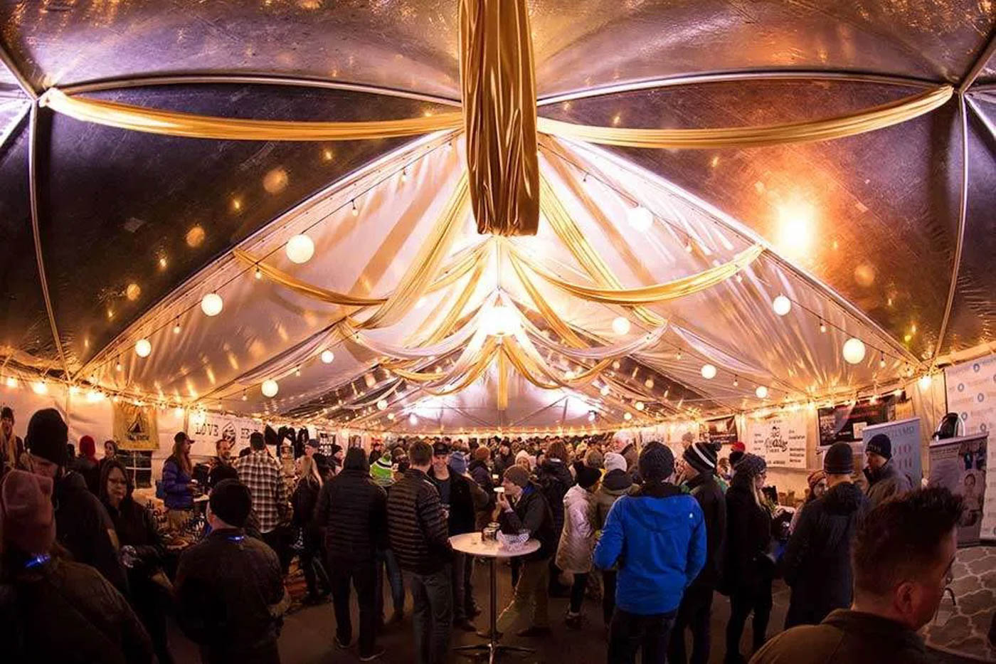 Crowds inside a luxury looking event tent at Winterfest in Bend.